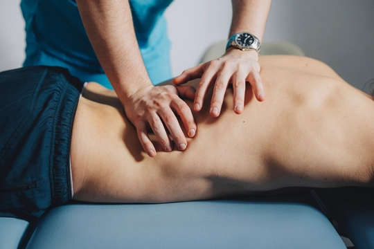 Chiropractor performing a diversified chiropractic adjustment.