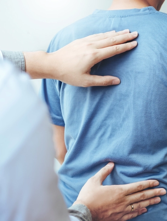 Chiropractor giving a back exam.