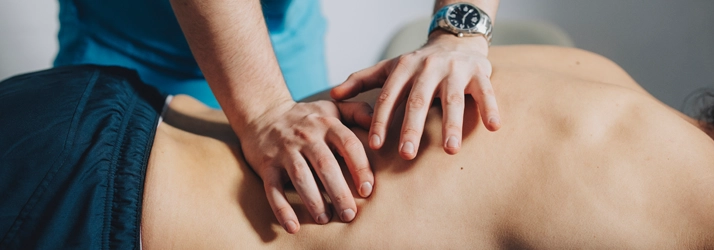 Chiropractic Huntsville AL Diversified Chiropractic Adjustments Chiropractor with his hands on a patients back.