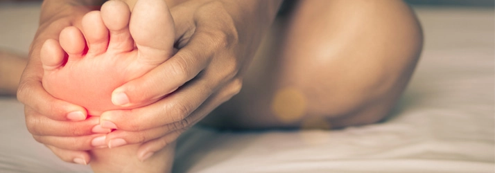 Chiropractic Huntsville AL Foot Person holding their foot in pain.
